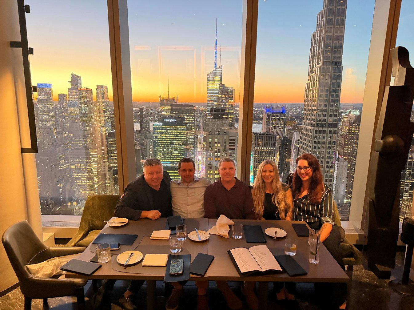 BuyerBridge team at dinner overlooking the New York City skyline at sunset